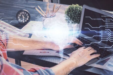Man with computer background with brain theme hologram. Concept of brainstorm. Double exposure.