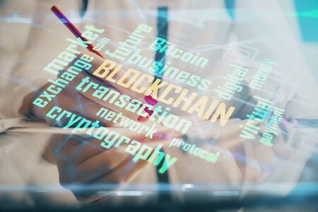 Cryptocurrency hologram over woman's hands writing background. Concept of blockchain. Double exposureの写真素材