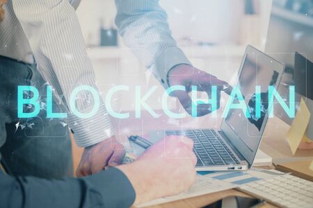 Crypto currency theme hologram with businessman working on computer on background. Concept of...