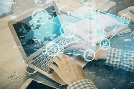 Social network theme hologram with businessman working on computer on background. Concept of world wide web. Double exposure.の写真素材