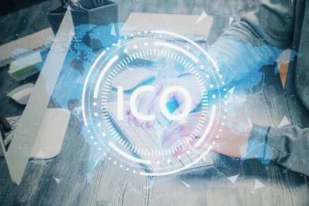 Blockchain theme hud with businessman working on computer on background. Concept of crypto chain. Multi exposure.の写真素材