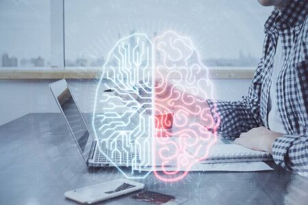 Man typing on keyboard background with brain hologram. Concept of big Data. Double exposure.の写真素材