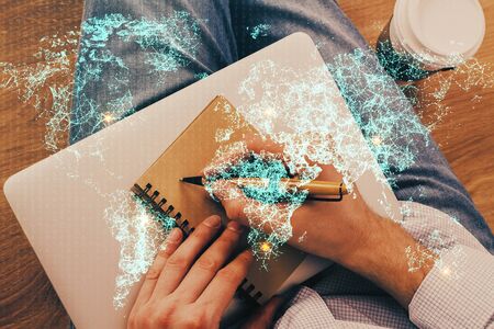 Man's hands working with notes background. Social networking scheme . Mixed media. Global business. Multi exposure.の写真素材