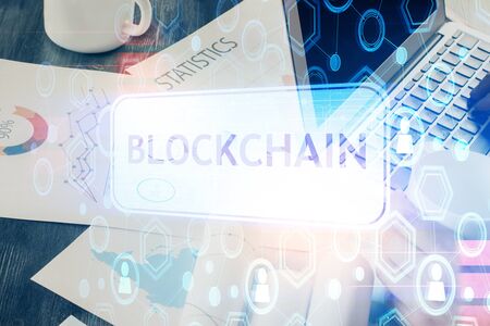 Crypto currency theme hologram with businessman working on computer on background. Concept of...
