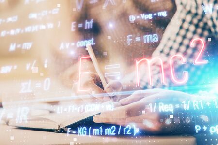 Student or teacher with mathematical and scientific formulas. Concepts of education. Symbols and equations on a virtual interface. Double exposure.の写真素材