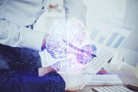 Man's hands with atificial intelligence double exposure icon. Concept of computer learning.の写真素材