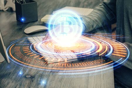 Blockchain theme hud with businessman working on computer on background. Concept of crypto chain. Double exposure.の写真素材
