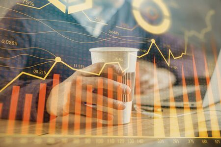 Forex graph with businessman working on computer in office on background. Concept of hardworking. Closeup. Multi exposure.の写真素材