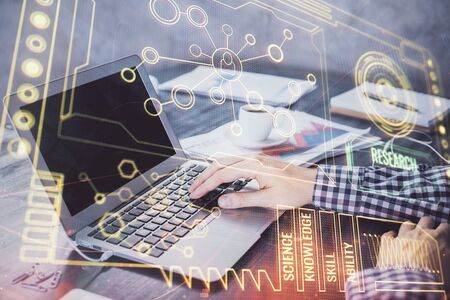 Businessman with computer background with technology theme hologram. Concept of hightech. Multi exposure.の写真素材