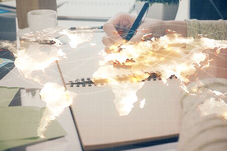 International business hologram over woman's hands taking notes background. Concept of success. Double exposureの写真素材