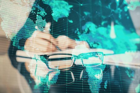 International business hologram over woman's hands taking notes background. Concept of success. Double exposureの写真素材