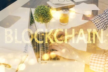 Blockchain theme hud with businessman working on computer on background. Concept of crypto chain. Multi exposure.の写真素材