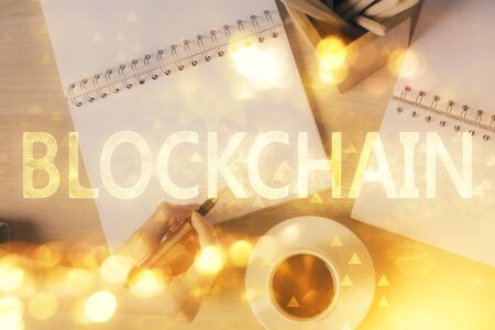 Cryptocurrency hologram over woman's hands writing background. Concept of blockchain. Double exposureの写真素材