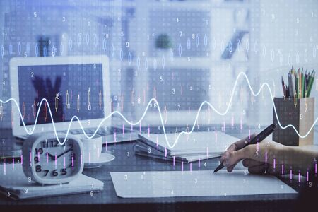 Financial graph displayed on woman's hand taking notes background. Concept of research. Multi...