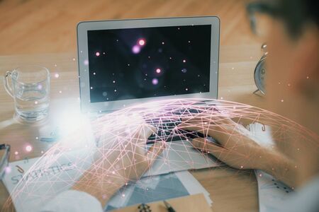 Social network theme hologram with businessman working on computer on background. Concept of world wide web. Double exposure.の写真素材