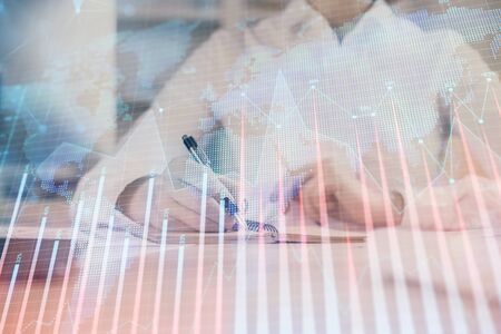Financial chart drawn over hands taking notes background. Concept of research. Multi exposureの写真素材
