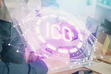 Crypto currency theme hologram with businessman working on computer on background. Concept of blockchain. Multi exposure.の写真素材