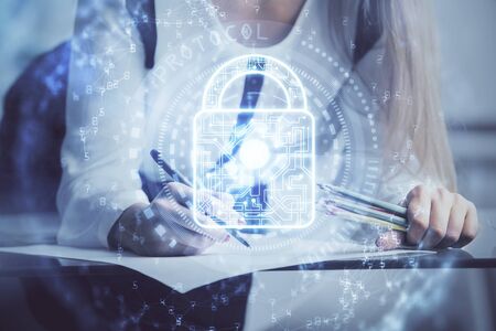 Double exposure of hands making notes with lock icons. Concept security and protection of dataの写真素材