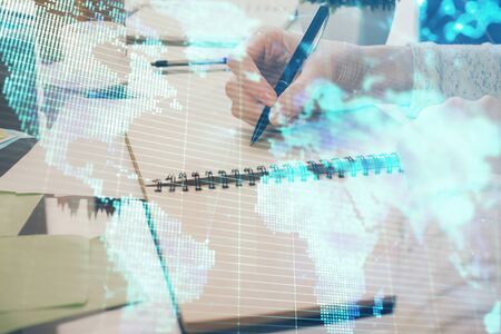 International business hologram over womans hands taking notes background. Concept of success. Double exposureの写真素材