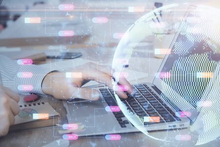 Multi exposure of world map hologram with man working on computer on background. Concept of worldwideweb.の写真素材