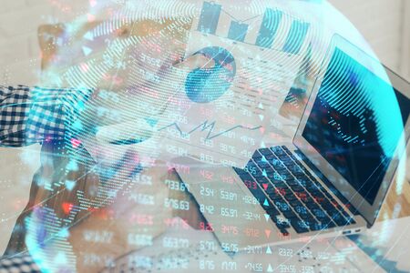 Double exposure of businessman working on laptop on background. International business hologram in front. Concept of success.の写真素材