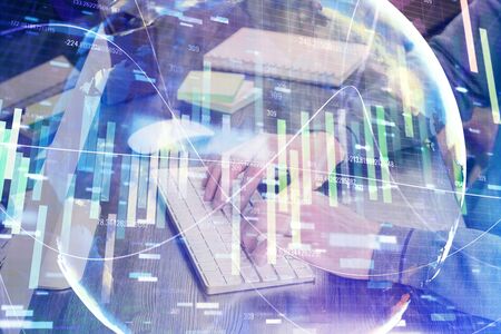 Double exposure of businessman working on laptop on background. International business hologram in front. Concept of success.の写真素材