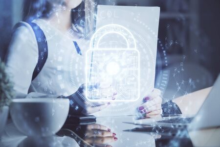 Double exposure of hands making notes with lock icons. Concept security and protection of dataの写真素材