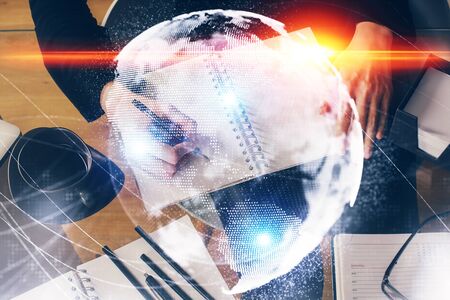 International business hologram over womans hands taking notes background. Concept of success. Double exposureの写真素材