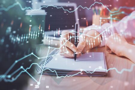 Forex chart displayed on womans hand taking notes background. Concept of research. Double exposure