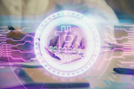 Cryptocurrency hologram over womans hands writing background. Concept of blockchain. Double exposureの写真素材