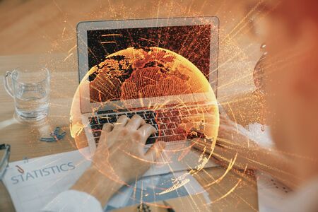 Social network theme hologram with businessman working on computer on background. Concept of world wide web. Double exposure.の写真素材