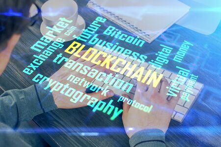 Blockchain theme hud with businessman working on computer on background. Concept of crypto chain. Multi exposure.の写真素材