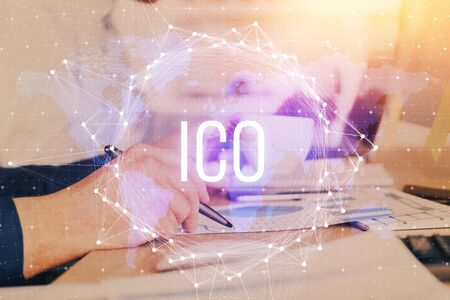 Man's hands working with notes background. Cryptocurrency and finance concept. Double exposure.の写真素材