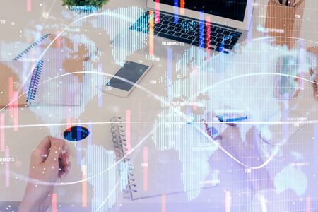 International business hologram over hands taking notes background. Concept of success. Multi exposureの写真素材