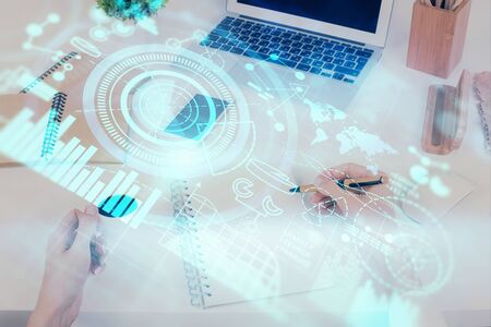 International business hologram over hands taking notes background. Concept of success. Multi exposureの写真素材