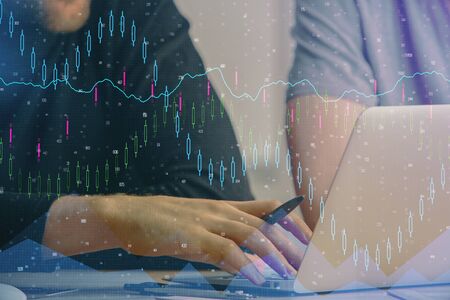 Forex graph with businessman typing on computer in office on background. Concept of analysis. Double...