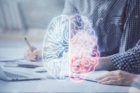 Man typing on keyboard background with brain hologram. Concept of big Data.の写真素材