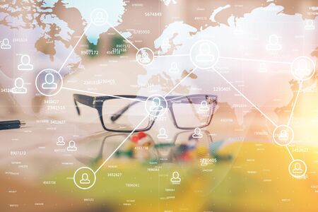 Social network theme drawing with glasses on the table background. Concept of people media connection. Double exposure.の写真素材