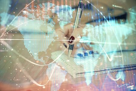 International business hologram over hands taking notes background. Concept of success. Multi exposureの写真素材