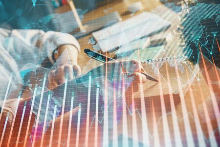 Financial forex charts displayed on womans hand taking notes background. Concept of research. Double...