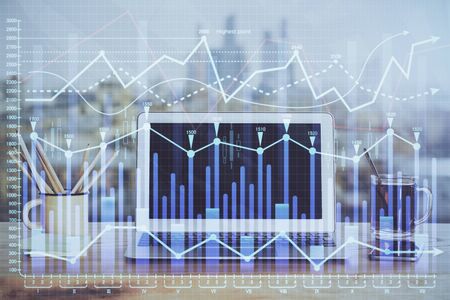 Forex market graph hologram and personal computer on background. Multi exposure. Concept of...
