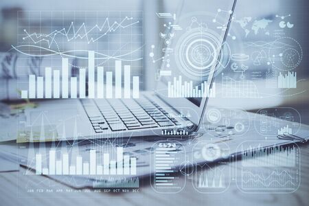 Forex market graph hologram and personal computer on background. Double exposure. Concept of...
