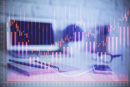 Stock market graph on background with desk and personal computer. Multi exposure. Concept of financial analysis.の写真素材