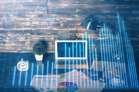 Double exposure of forex graph and work space with computer. Concept of international online trading.の写真素材