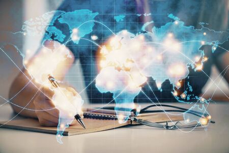 International business hologram over hands taking notes background. Concept of success. Multi exposureの写真素材