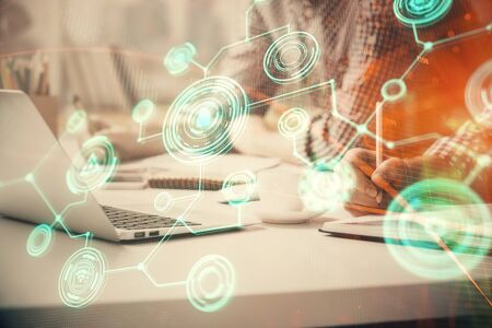 Social network theme hologram with businessman working on computer on background. Concept of world...