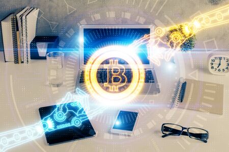 Double exposure of blockchain and crypto economy theme hologram and table with computer background....