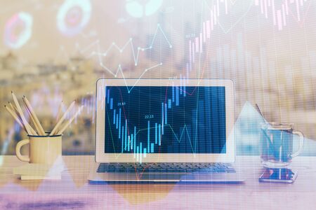 Stock market graph and table with computer background. Multi exposure. Concept of financial analysis.の写真素材