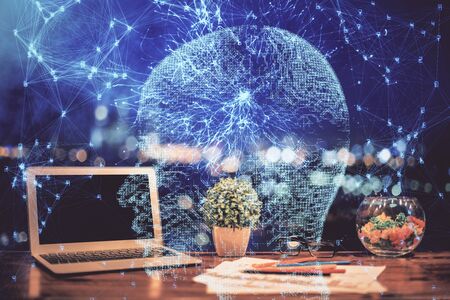 Double exposure of desktop with computer and brain drawing hologram. Artificial intelligence...