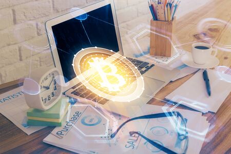 Double exposure of blockchain and crypto economy theme hologram and table with computer background. Concept of bitcoin cryptocurrency.の写真素材
